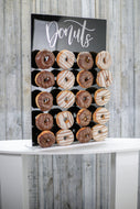 Black Acrylic Donut Wall, with Gold or Silver Donut Text. 43cm x 65cm. Holds 20-40 Donuts. Freestanding
