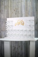 Shots Wall White With Acrylic Golds Shots Text 70x55cm. Holds 24 Shots. Freestanding